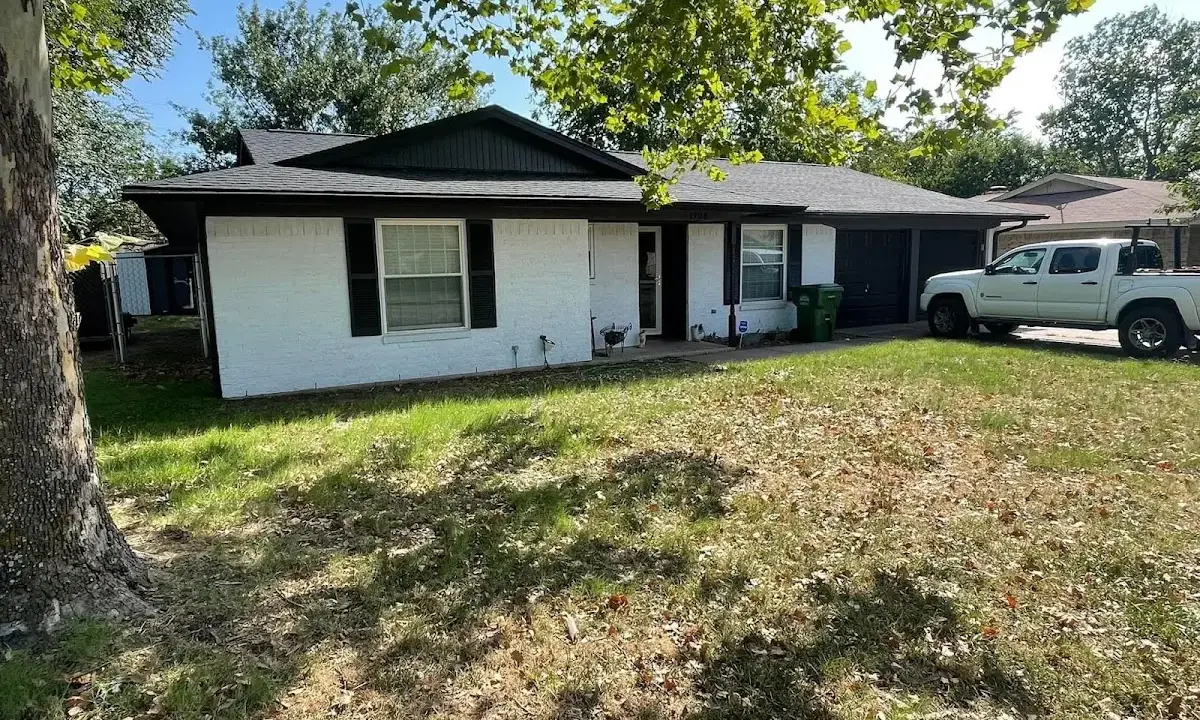 Professional roofing crew working on a residential roof in Bellefonte